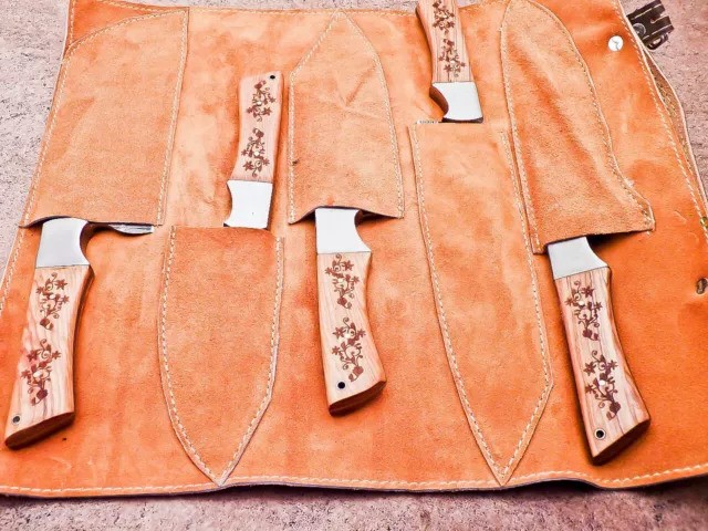 Damascus kitchen knife set stored in premium leather roll bag