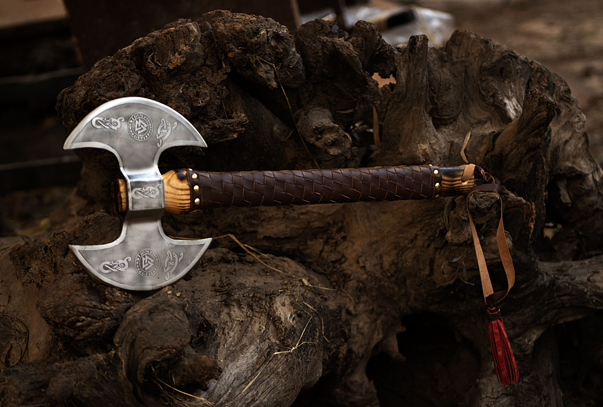 Leather wrapped olive wood handle of handmade Viking survival axe