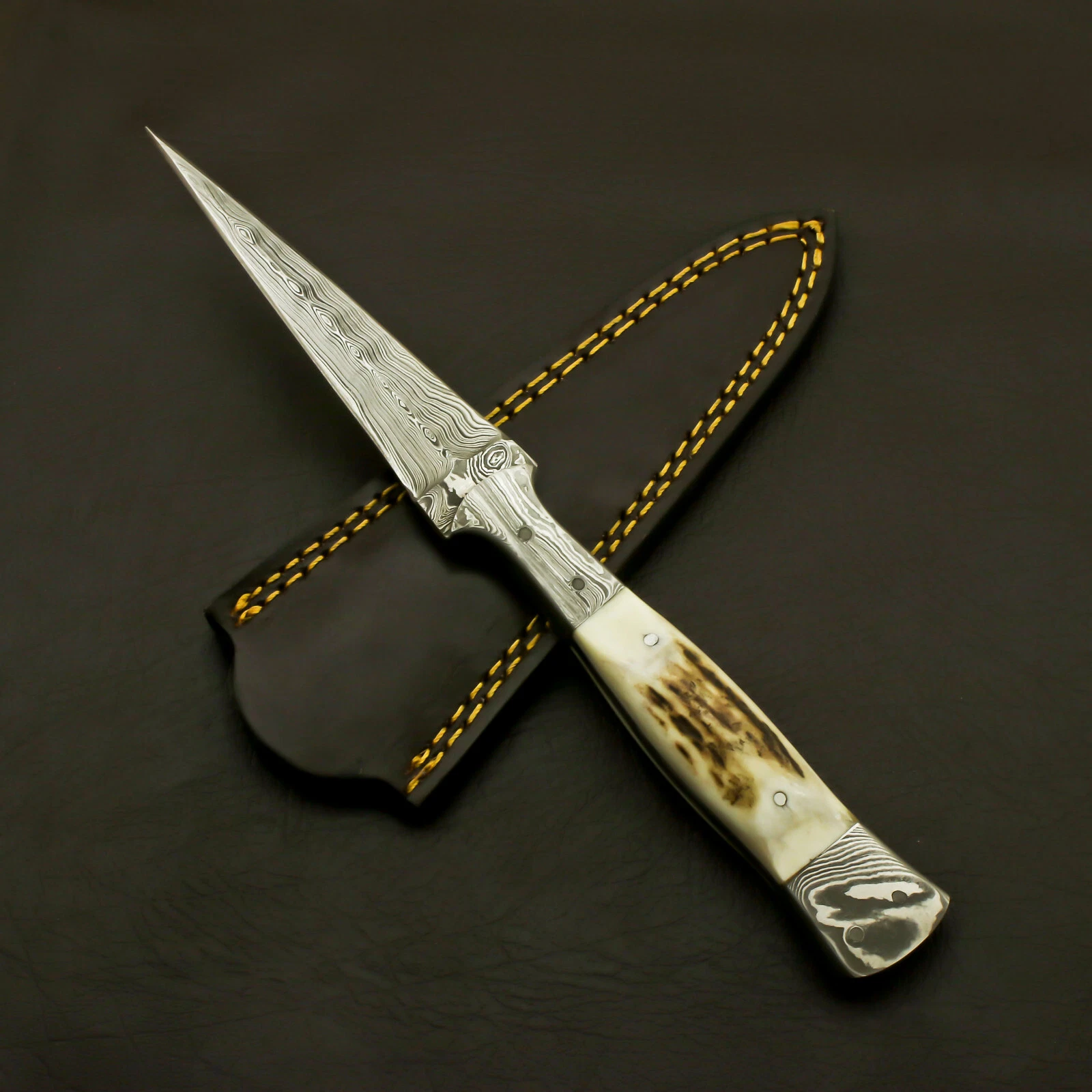 Handmade Damascus steel dual-edge dagger with 4 inch blade, full tang, and genuine stag handle with leather sheath