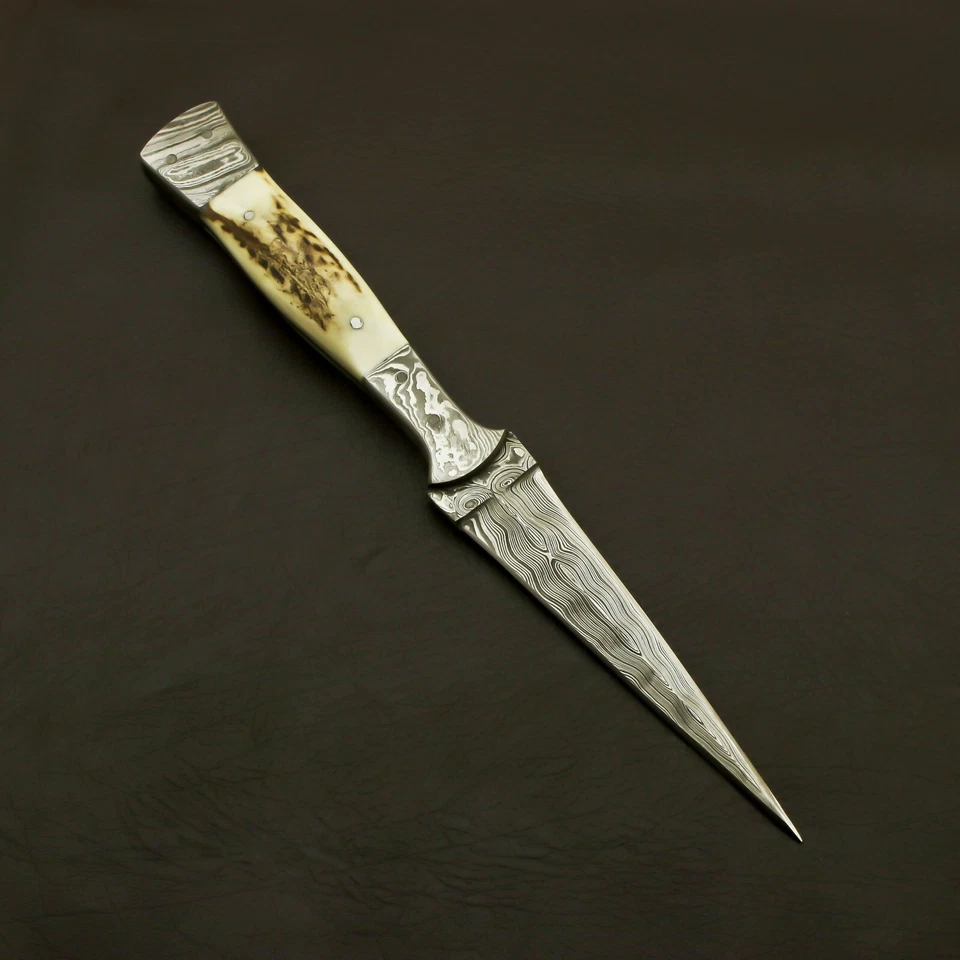 Close-up of Damascus steel dual-edge dagger blade showing layered steel pattern